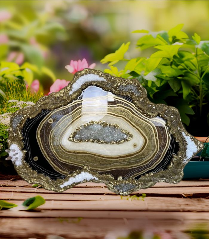 Golden glitter resin tray with a baby photo and birthday card on a craft workspac